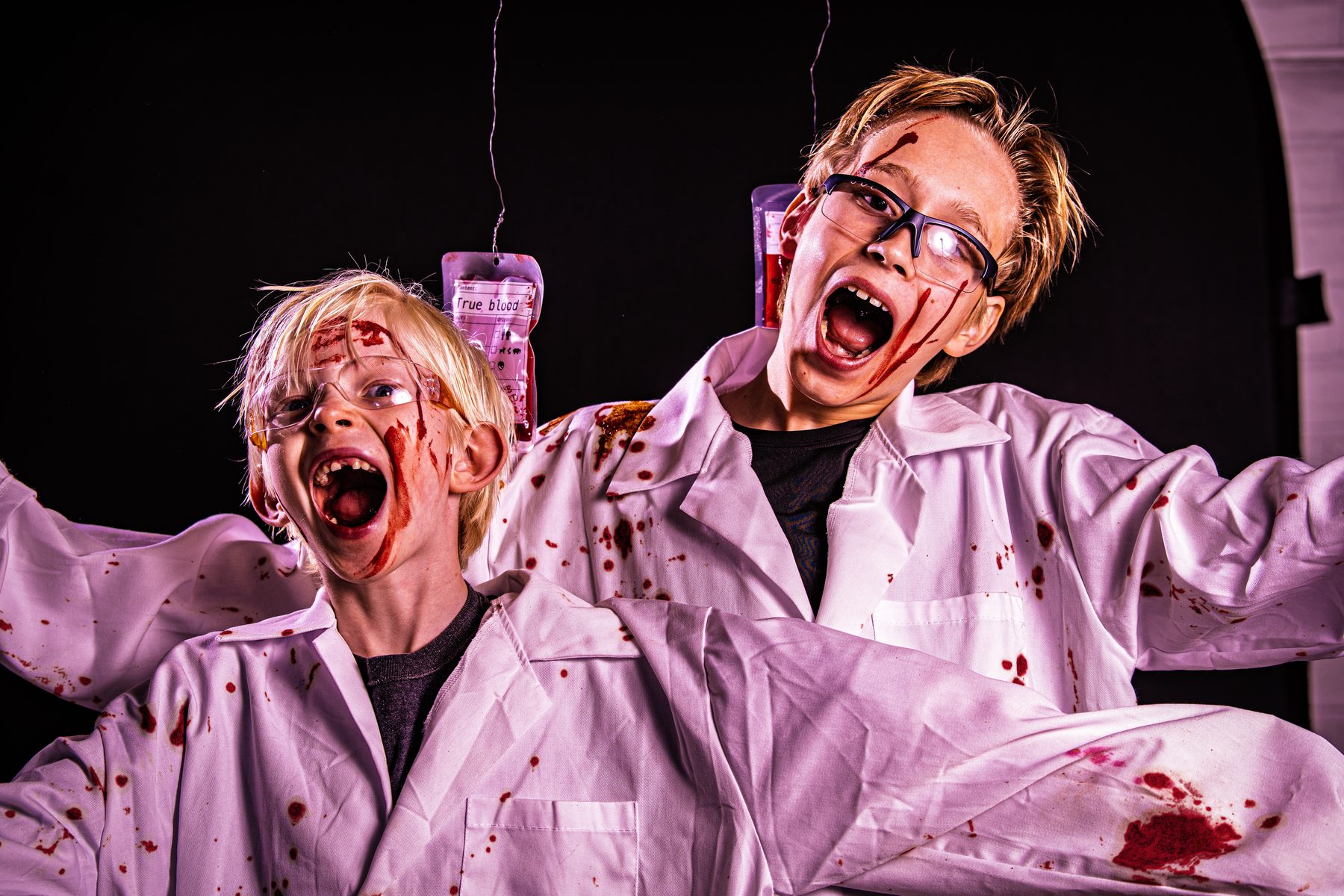 Both scientists screaming, arms wide, coats soaked in blood.