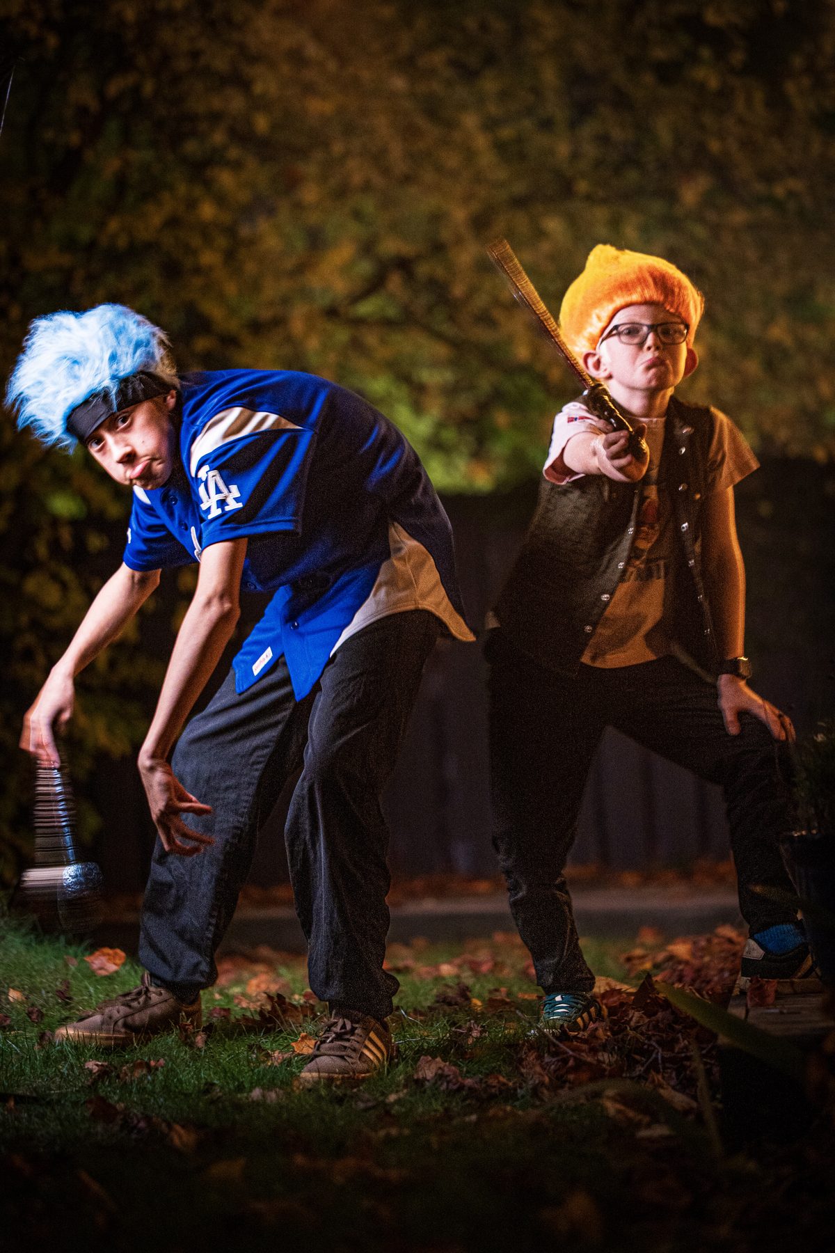 Blue troll swinging a hammer, orange troll pointing a sword.