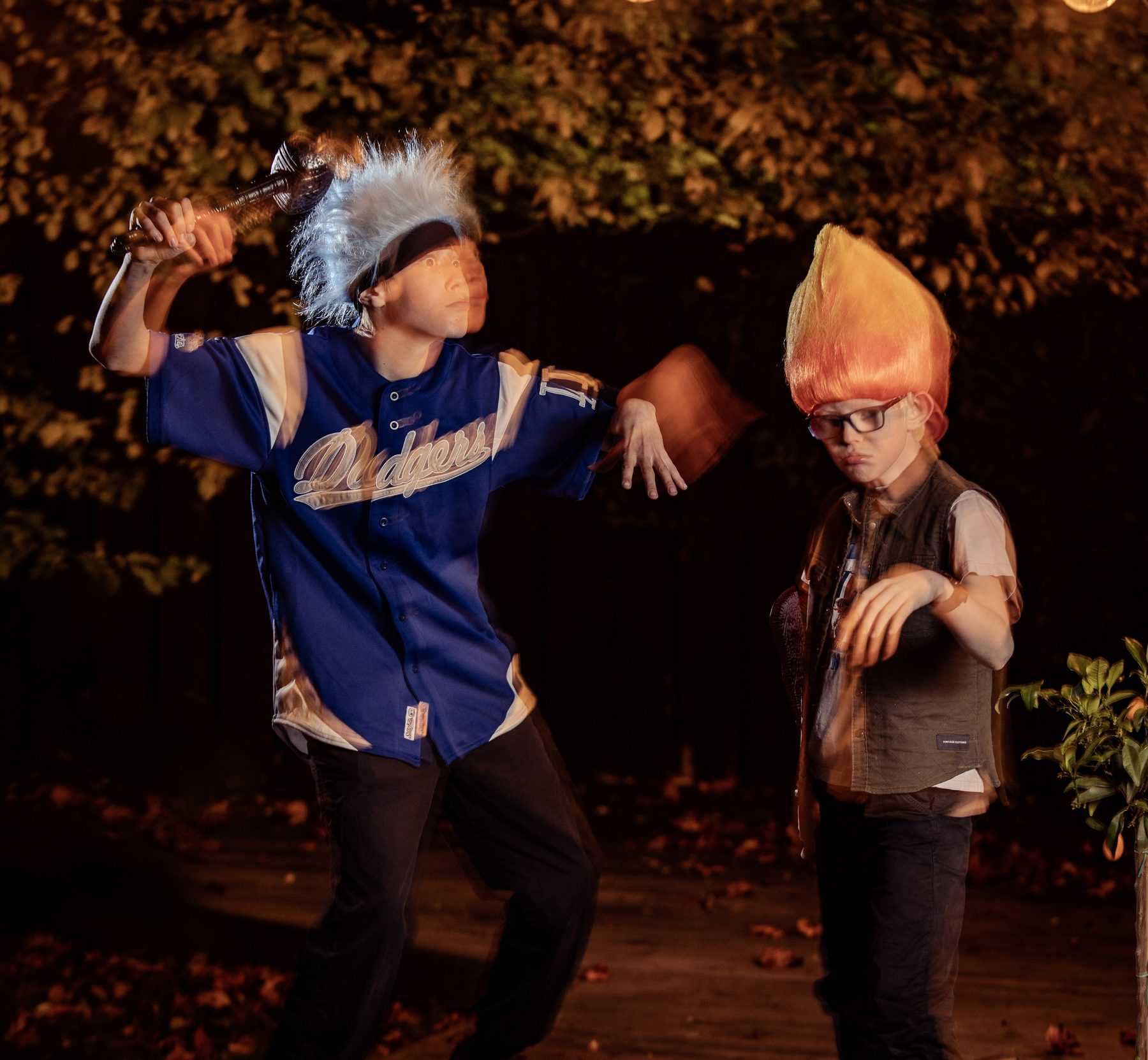Blue troll mid-swing in a motion blur, orange troll unimpressed.